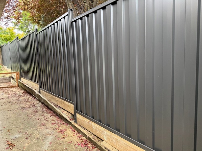 Grey Colorbond fence along a driveway