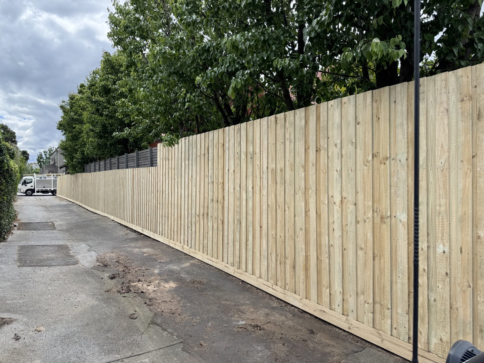Timber paling fence along a driveway