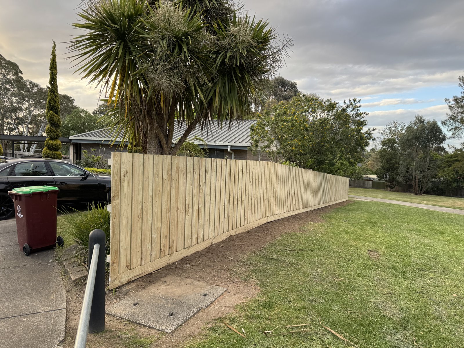 Timber paling fence in a front yard